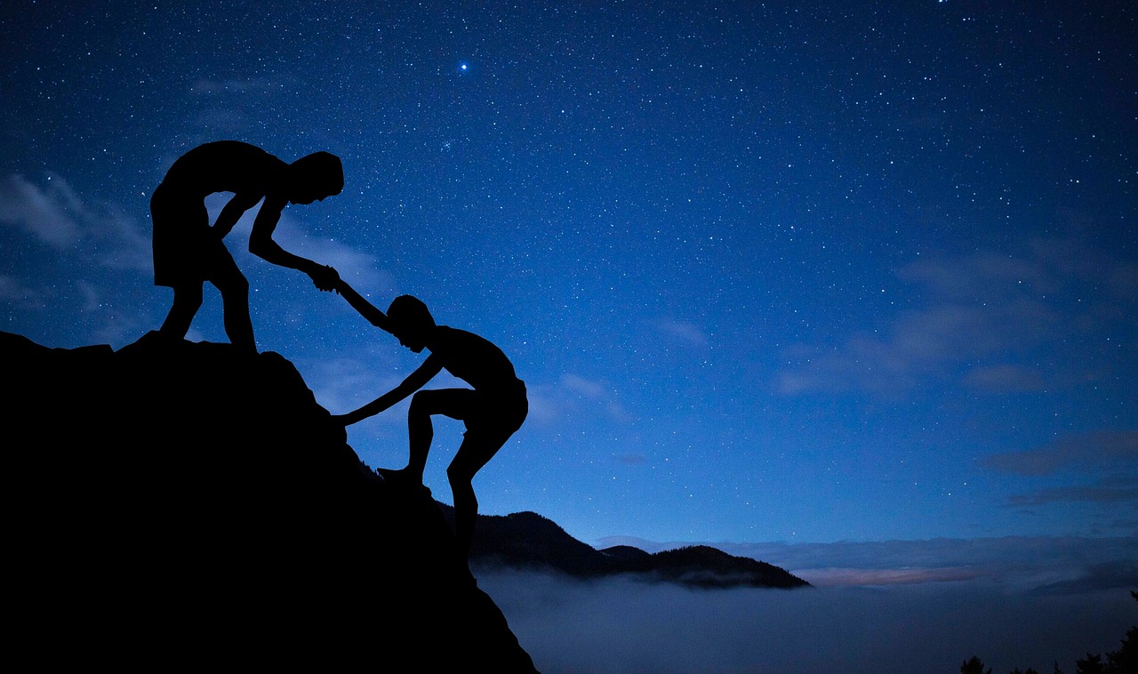 men mentor help climbing mountain 3610255